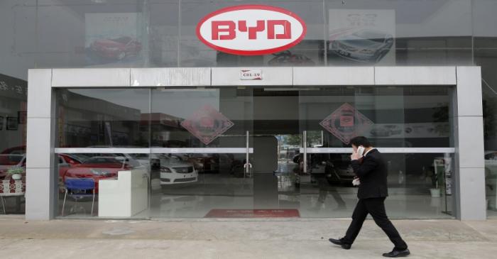 FILE PHOTO -  A man walks past a BYD store in Wuhan