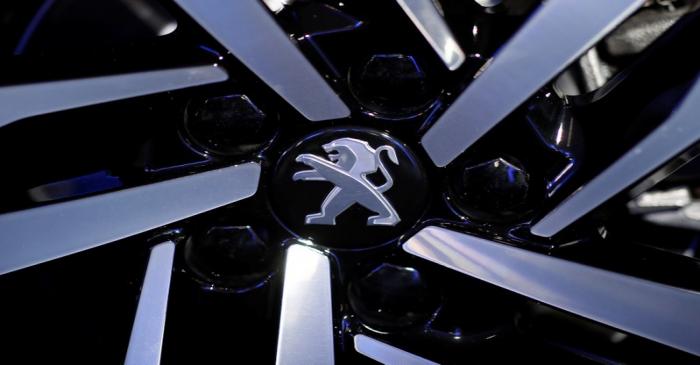 The Peugeot logo is pictured on the new Peugeot 508 before a news conference of PSA Group to