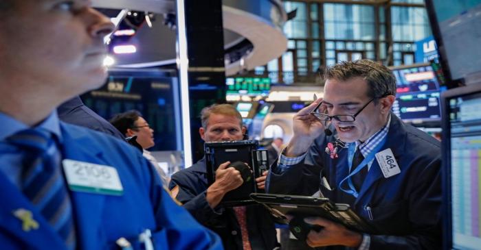 Traders work on the floor of the NYSE in New York