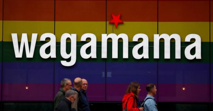 People walk past a branch of restaurant chain Wagamama in Manchester