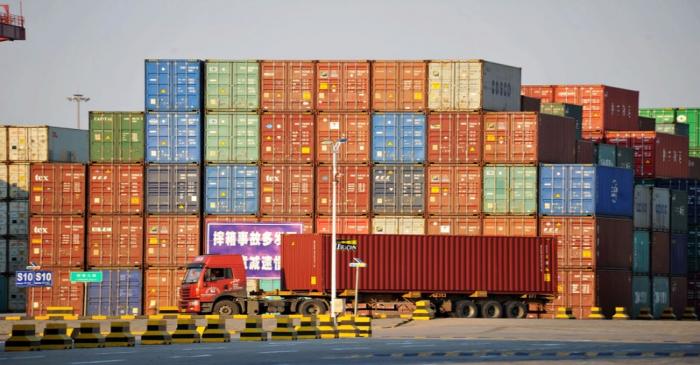 Truck transports a shipping container at Qingdao port in Shandong