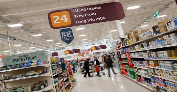 FILE PHOTO: Customers shop in a Sainsbury's store in Redhill