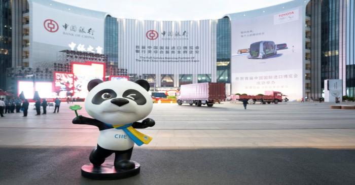 Statue of the China International Import Expo (CIIE)'s mascot is placed in front of a building