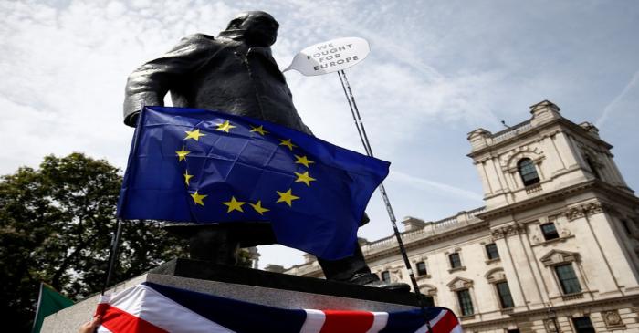 An EU flag is draped across the statue of Winston Chruchill in Parliament Square, as EU