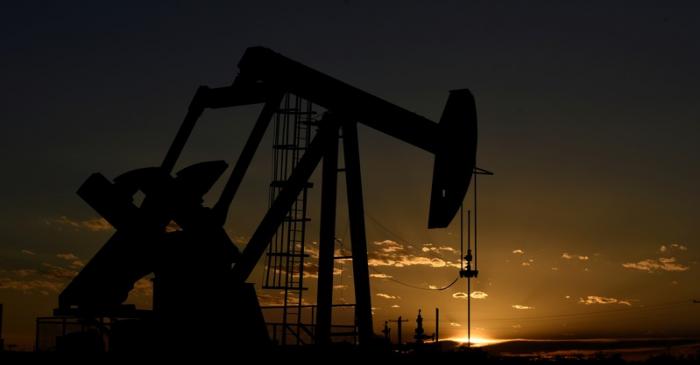 FILE PHOTO: A pump jack on a lease owned by Parsley Energy operates at sunset in the Permian