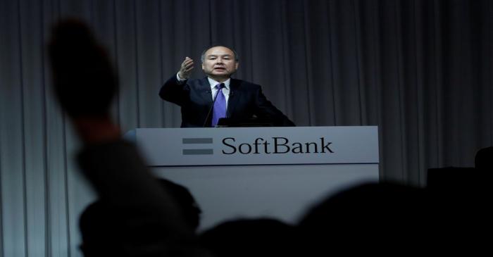 A journalist raises her hand to ask a question to Japan's SoftBank Group Corp Chief Executive