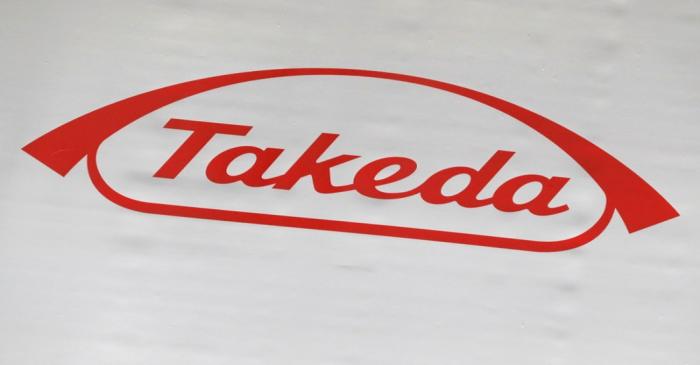 FILE PHOTO: The logo of Takeda Pharmaceutical Co. is displayed at the company's news conference