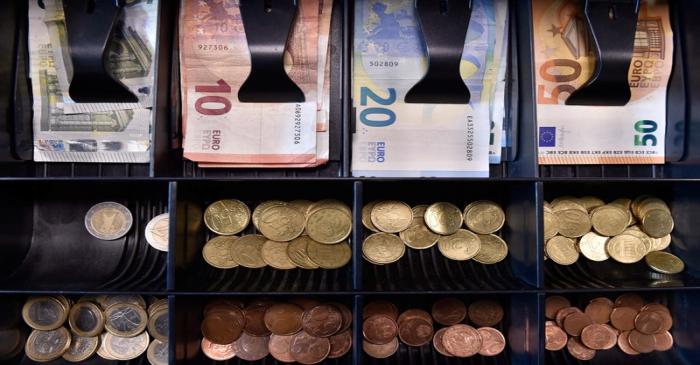 FILE PHOTO:  Euro banknotes and coins are displayed in a shop in Brussels