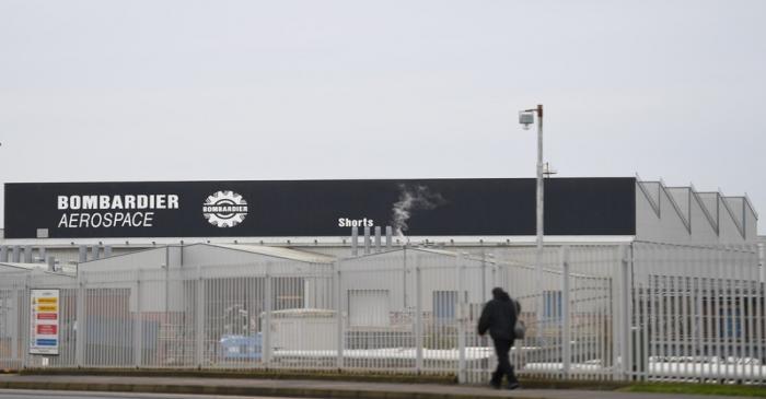 FILE PHOTO: A man walks past the Bombardier plant in Belfast