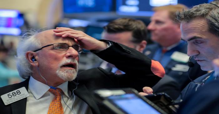 FILE PHOTO: Traders work on the floor of the NYSE in New York