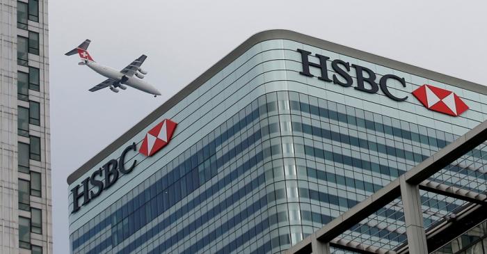 FILE PHOTO: A Swiss International aircraft flies past the HSBC headquarters building in the