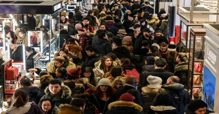 A large crowd of people shop during a Black Friday sales event at Macy's flagship store in New