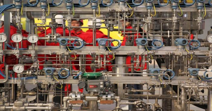 Workers inspect facilities at a compressor station for CNPC's Shaanxi-Beijing natural gas