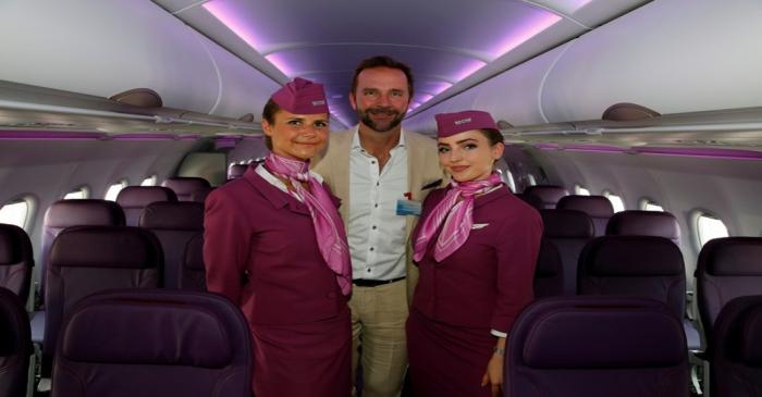 FILE PHOTO: Skuli Mogensen, CEO of WOW air, poses with cabin crew members during a delivery