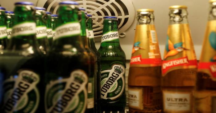 Bottles of Kingfisher and Tuborg beer are displayed in a fridge at a pub in Mumbai