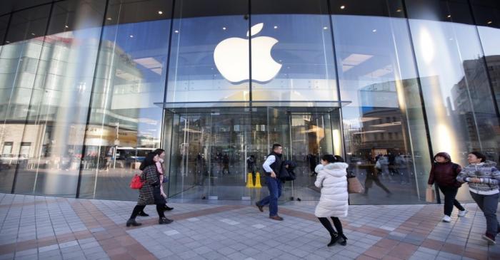 People walk outside an Apple store in Beijing