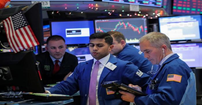 Traders work on the floor of the NYSE in New York