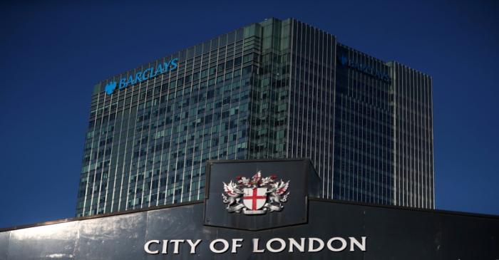 FILE PHOTO: Barclays' building in Canary Wharf is seen behind a City of London sign outside