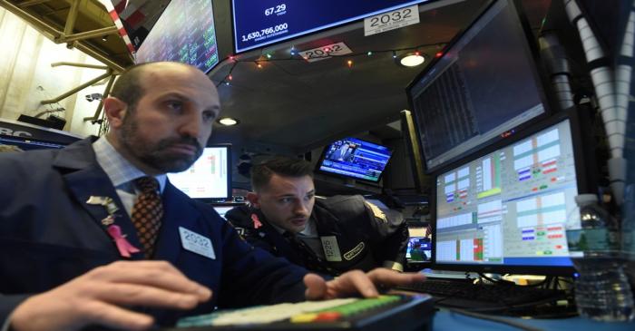 Traders work on the floor of the NYSE in New York