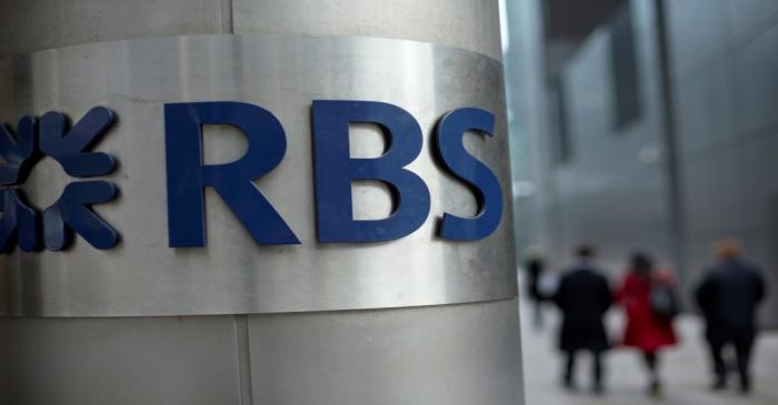 FILE PHOTO: People walk past a Royal Bank of Scotland office in London