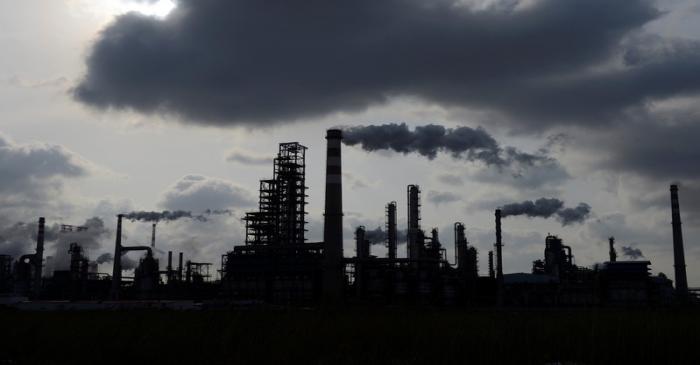 FILE PHOTO - Smoke rises from chimneys at a Sinopec refinery in Qingdao