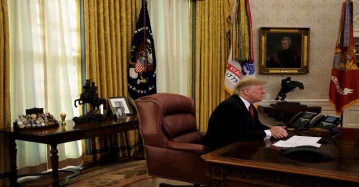 U.S. President Donald Trump holds a video call with U.S. military service members in the Oval