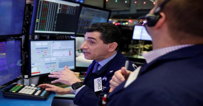 Traders work on the floor of the New York Stock Exchange shortly after the opening bell in New