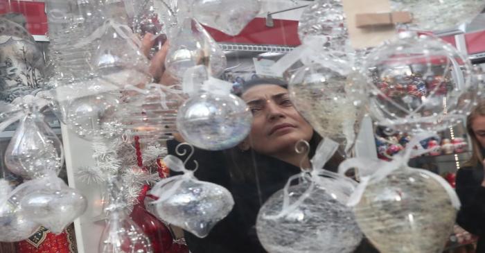 A woman shops for holiday ornaments at the Bryant Park Winter Village in New York