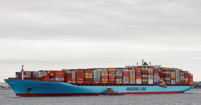 A Maersk container ship is guided by a tug boat in New York Harbor in New York