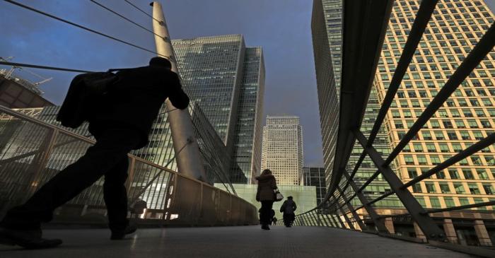 People walk through the Canary Wharf financial district of London