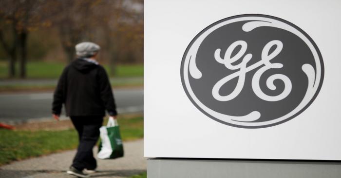 FILE PHOTO: A pedestrian walks past a General Electric facility in Medford