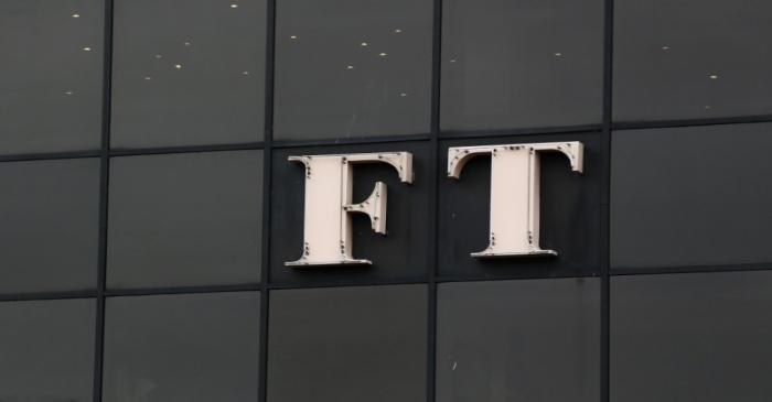 A company logo hangs on the headquarters of the Financial Times newspaper in London