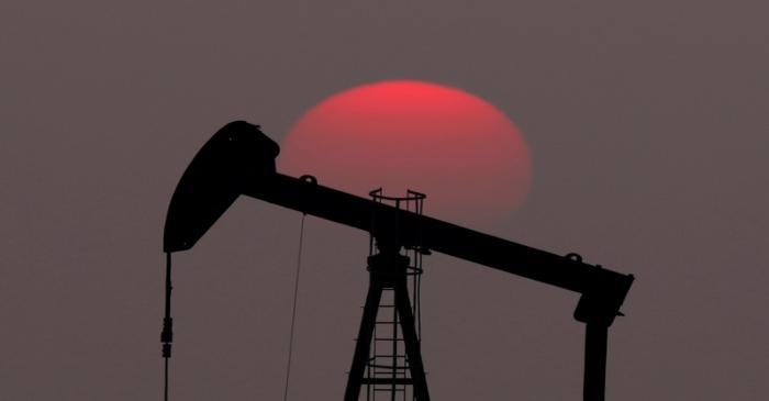 FILE PHOTO: The sun sets behind a pump-jack outside Saint-Fiacre