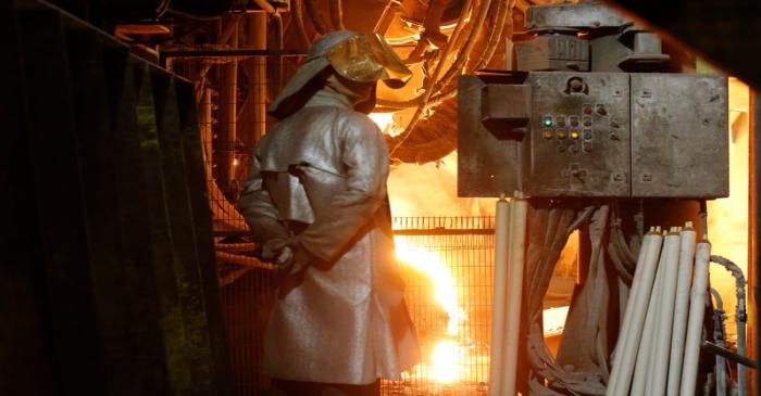 A steelworker watches the casting of molten metal at the Ascoval steelworks in Saint-Saulve