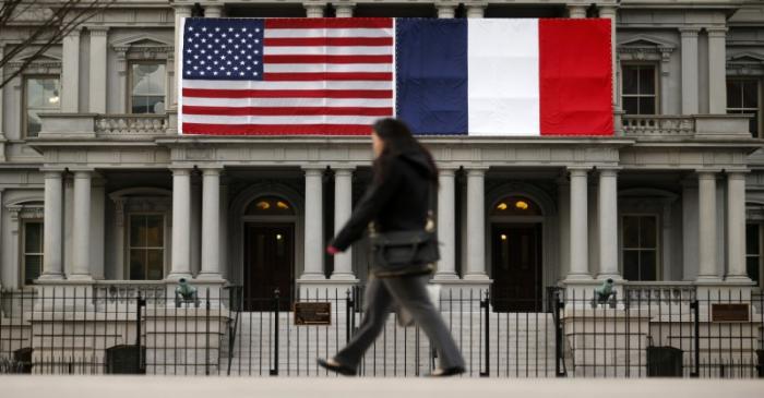 U.S. and French flags fly next to the White House to honor French President Hollande in