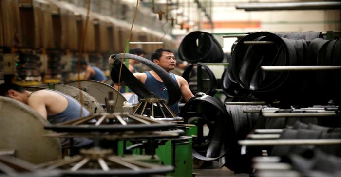 An employee works on the production line of a tyre factory under Tianjin Wanda Tyre Group in