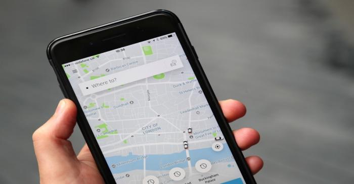 The Uber app is seen on mobile telephone in London