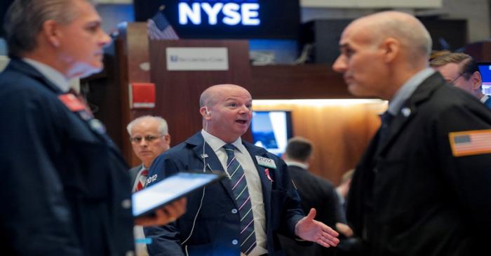 Traders work on the floor at the NYSE in New York