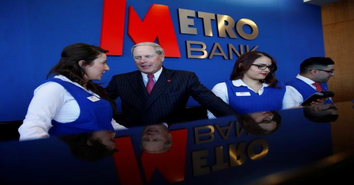 FILE PHOTO: Metro Bank Chairman Vernon Hill poses for a photograph with bank staff at their new