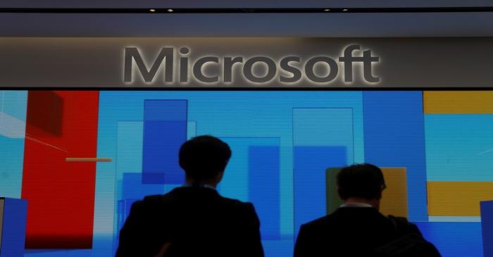 FILE PHOTO: Visitors stand in front of a display screen at Microsoft's new Oxford Circus store