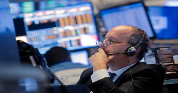 Traders work on the floor at the NYSE in New York