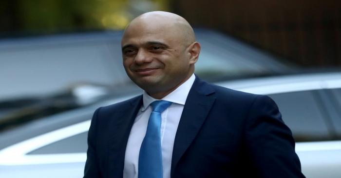 Britain's Chancellor of the Exchequer Sajid Javid walks outside Downing Street in London