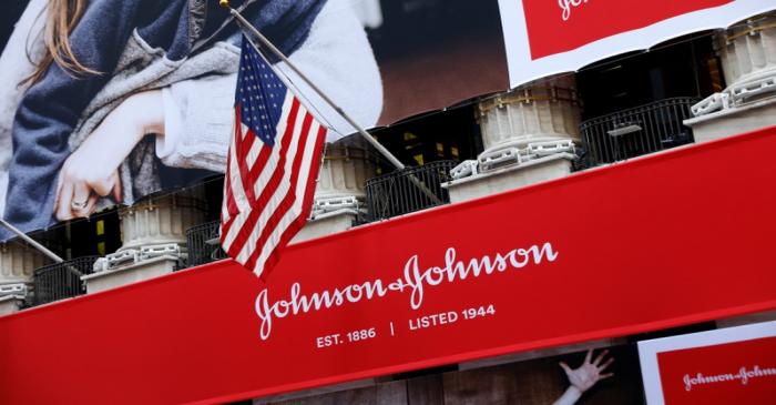 The U.S. flag is seen over the company logo for Johnson & Johnson to celebrate the 75th