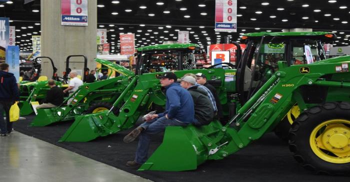 FILE PHOTO: People look at Deere equipment as they attend National Farm Machinery show in