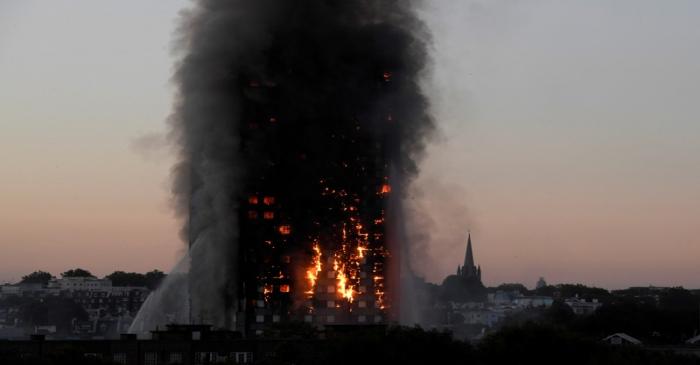 FILE PHOTO: Flames and smoke billow as firefighters deal with a serious fire in the Grenfell