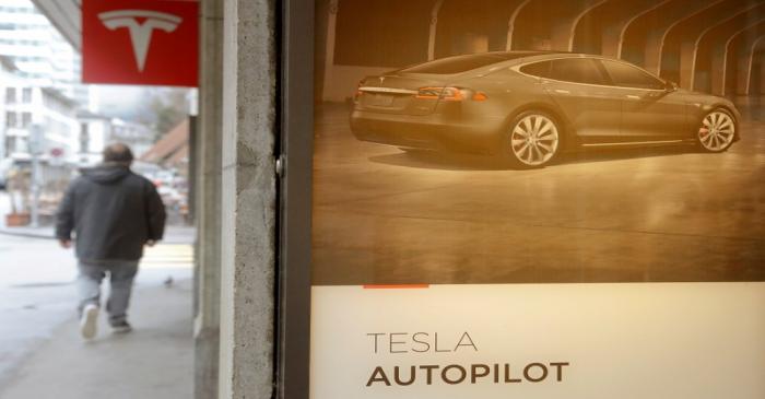 Advertisement promotes Tesla Autopilot at a showroom of U.S. car manufacturer Tesla in Zurich