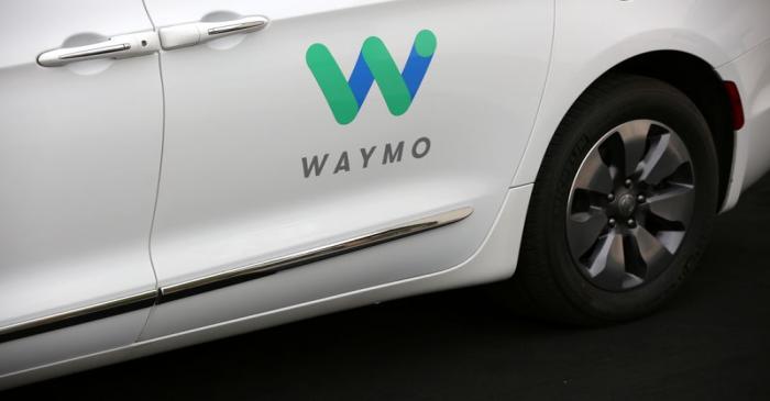 A Waymo Chrysler Pacifica Hybrid self-driving vehicle is parked and displayed during a