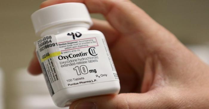 FILE PHOTO: A pharmacist holds a bottle OxyContin made by Purdue Pharma at a pharmacy in Provo,