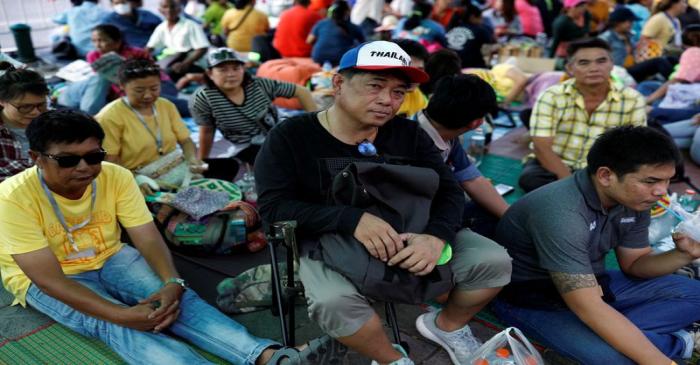 Family members in the fishing industry sit at a protest outside the Agriculture Ministry in