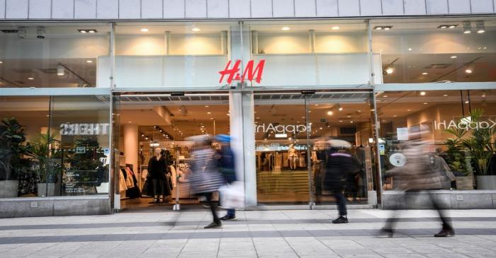 People walk past an H&M store in Stockholm